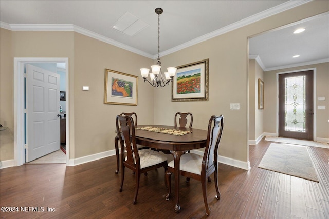 dining space with dark hardwood / wood-style flooring, ornamental molding, and a notable chandelier