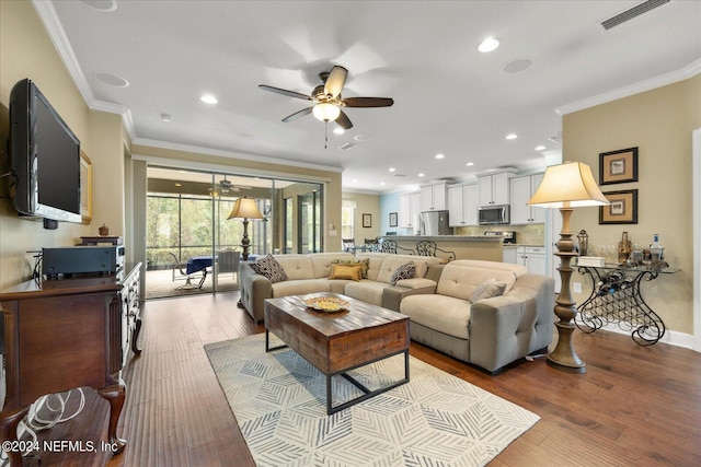 living room with ceiling fan, light hardwood / wood-style flooring, and ornamental molding