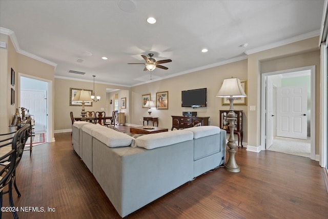 living room featuring dark hardwood / wood-style flooring, ceiling fan with notable chandelier, and ornamental molding