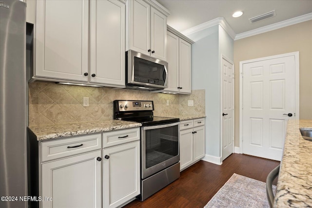 kitchen with decorative backsplash, light stone countertops, ornamental molding, dark hardwood / wood-style flooring, and stainless steel appliances