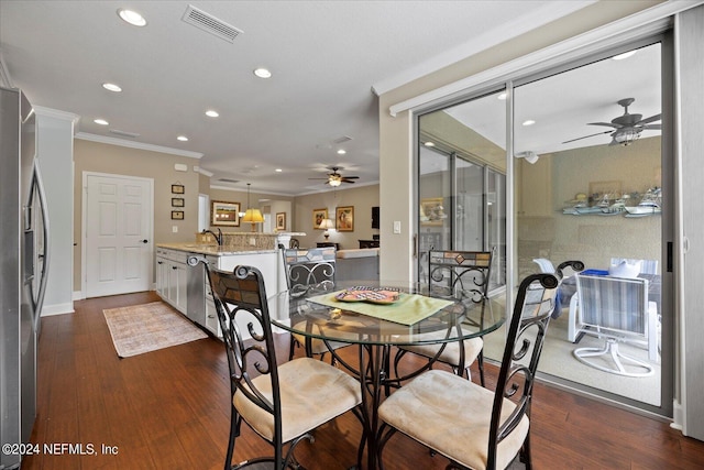 dining area featuring ceiling fan, dark hardwood / wood-style floors, ornamental molding, and sink