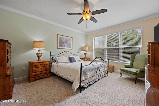 bedroom featuring ceiling fan, crown molding, and carpet floors