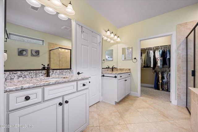 bathroom with vanity, tile patterned floors, and an enclosed shower