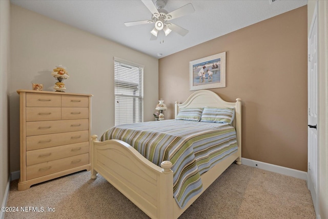 bedroom with ceiling fan and light colored carpet