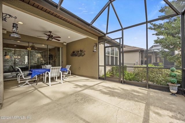 unfurnished sunroom featuring ceiling fan