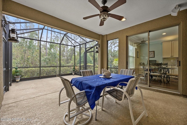 view of patio with ceiling fan and a lanai