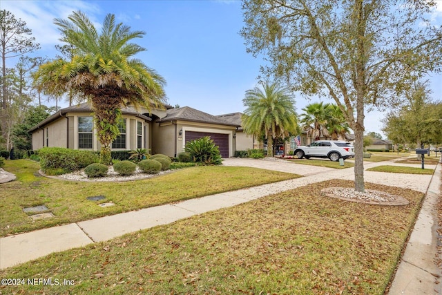 view of front of property featuring a front yard and a garage