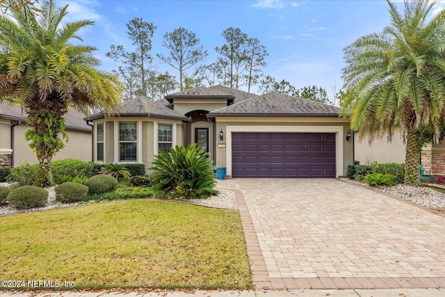 view of front of home featuring a garage and a front lawn