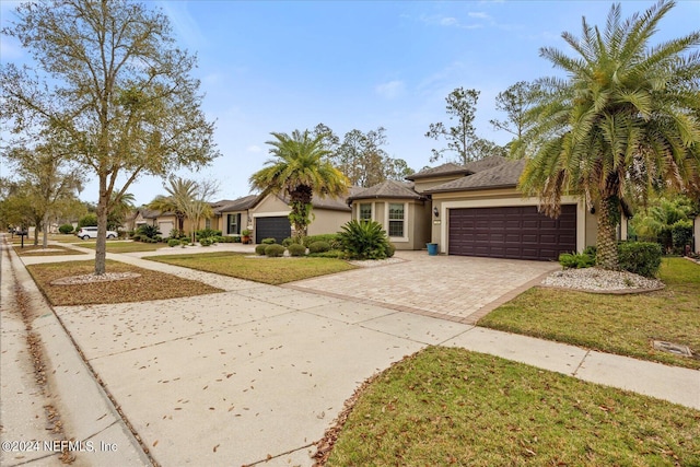 view of front of home featuring a front yard and a garage