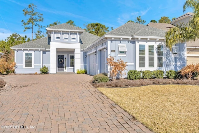 view of front of home featuring a garage and a front lawn