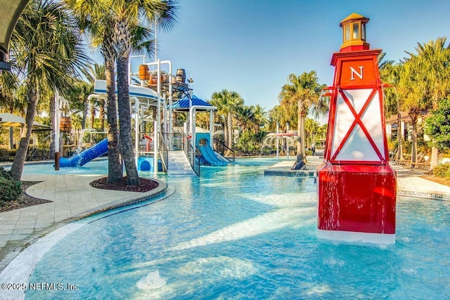 view of swimming pool featuring a playground