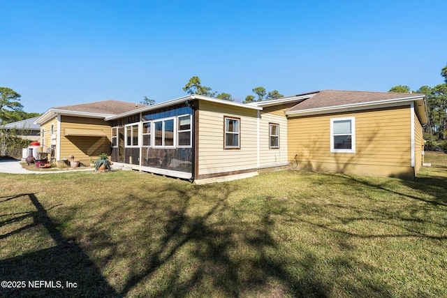 rear view of house with a yard