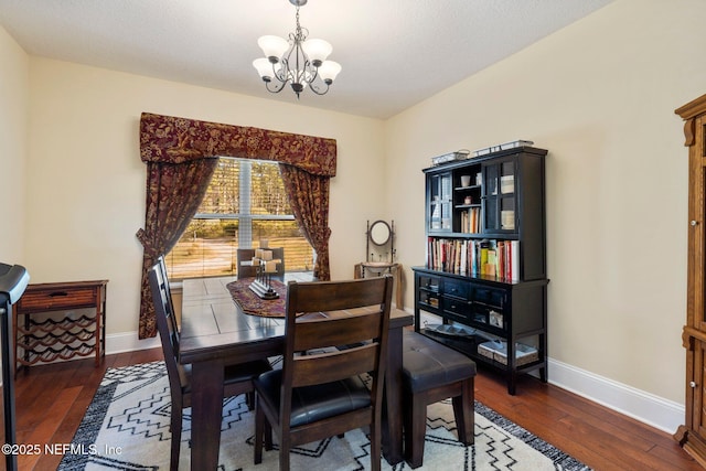 dining area featuring a chandelier and dark hardwood / wood-style floors