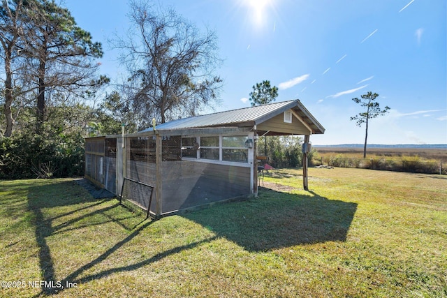 view of yard featuring a rural view and an outbuilding