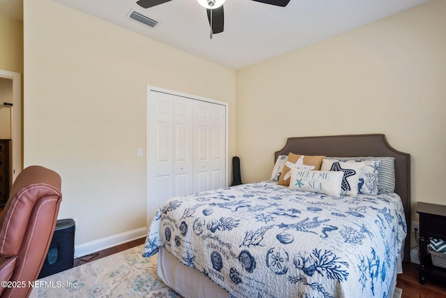 bedroom with a closet, ceiling fan, and dark hardwood / wood-style floors