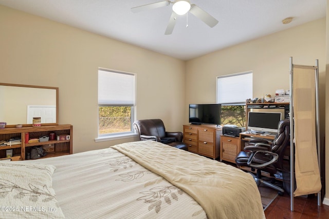 bedroom with ceiling fan and dark wood-type flooring