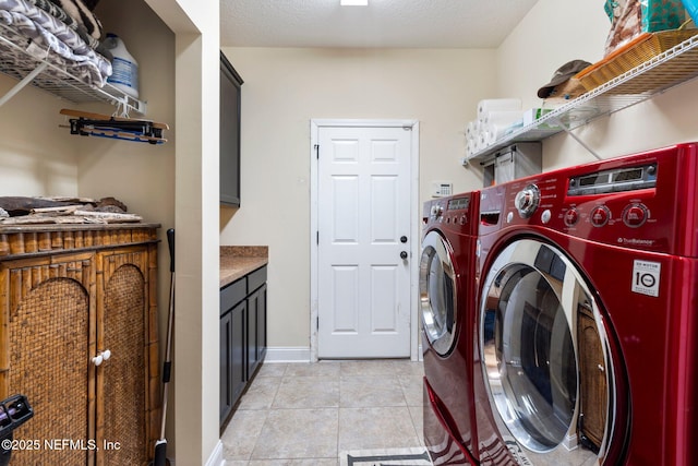 washroom with light tile patterned floors and washing machine and clothes dryer