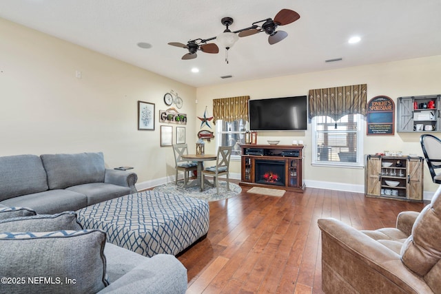 living room with hardwood / wood-style floors and ceiling fan