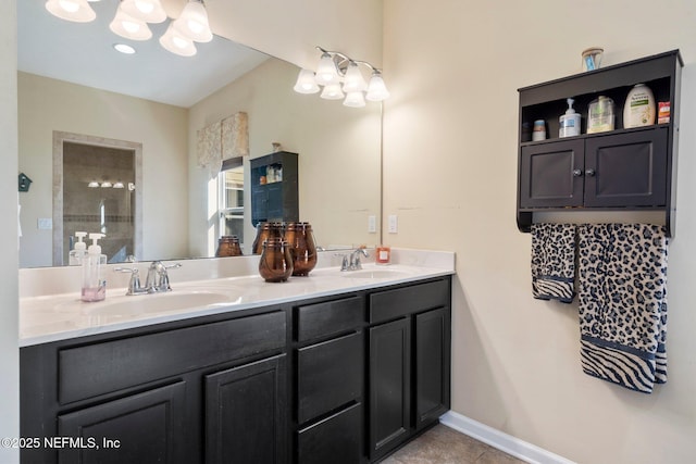 bathroom featuring tile patterned flooring, a tile shower, and vanity