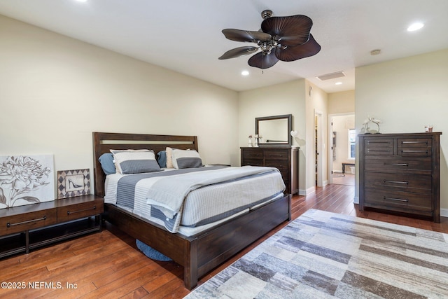 bedroom with ceiling fan and dark hardwood / wood-style floors