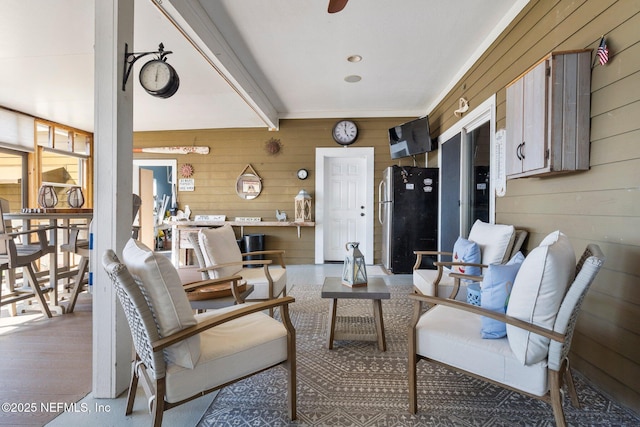 living room featuring wood walls