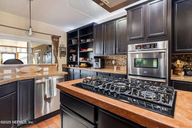 kitchen with tasteful backsplash, dark brown cabinetry, stainless steel appliances, decorative light fixtures, and butcher block counters