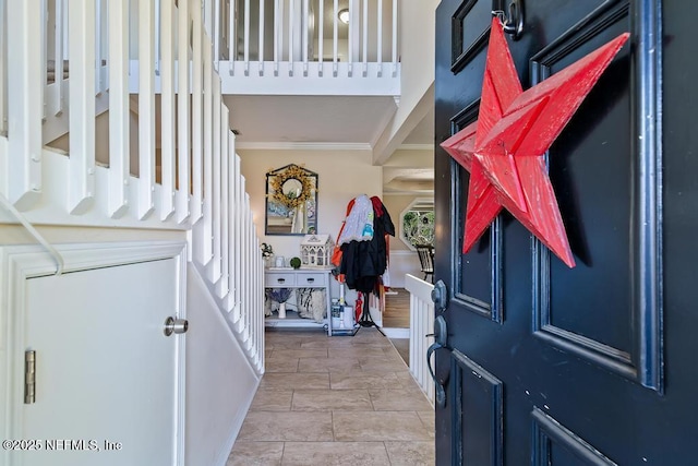 foyer featuring crown molding