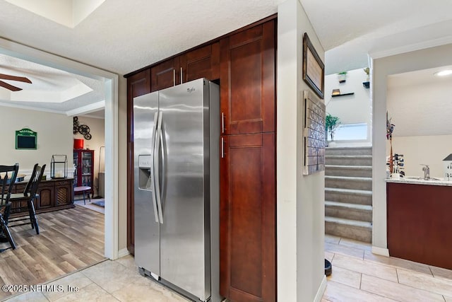 kitchen with light tile patterned flooring, sink, a textured ceiling, stainless steel fridge, and ceiling fan