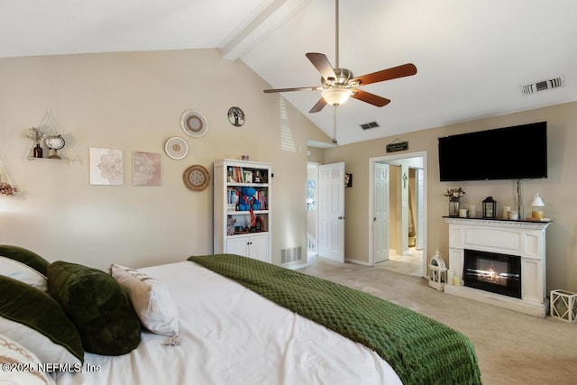 carpeted bedroom featuring vaulted ceiling with beams and ceiling fan