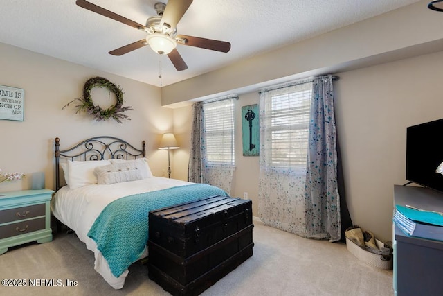 bedroom featuring ceiling fan and light carpet