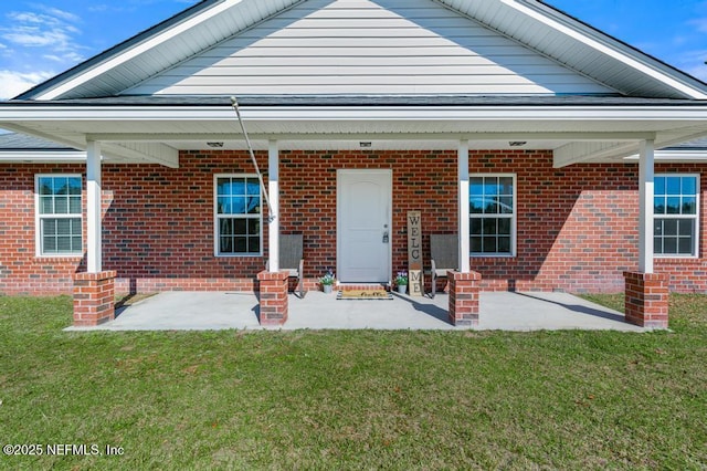 rear view of property with a yard