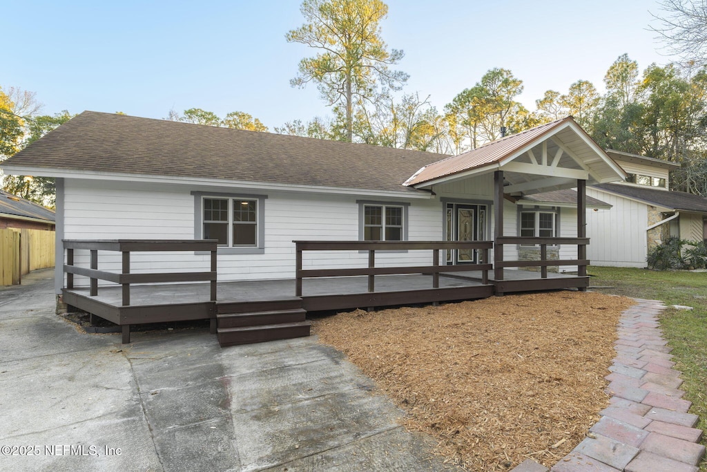 view of front of property with a deck and ceiling fan