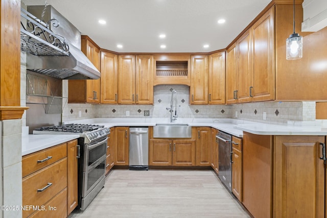 kitchen with backsplash, exhaust hood, decorative light fixtures, range with two ovens, and light hardwood / wood-style floors