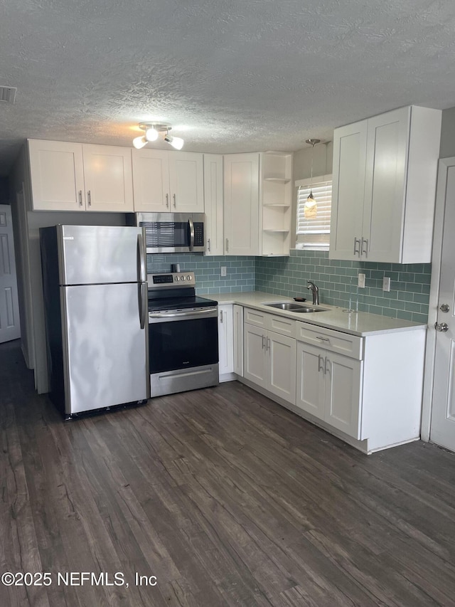 kitchen featuring dark hardwood / wood-style floors, white cabinetry, sink, and appliances with stainless steel finishes