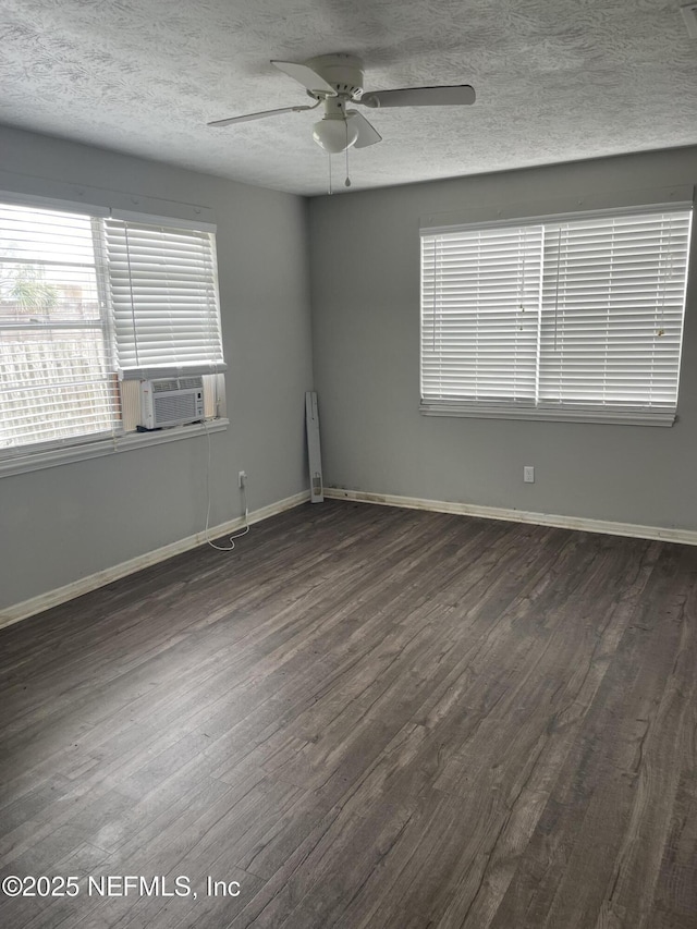 spare room featuring a textured ceiling, cooling unit, ceiling fan, and dark wood-type flooring