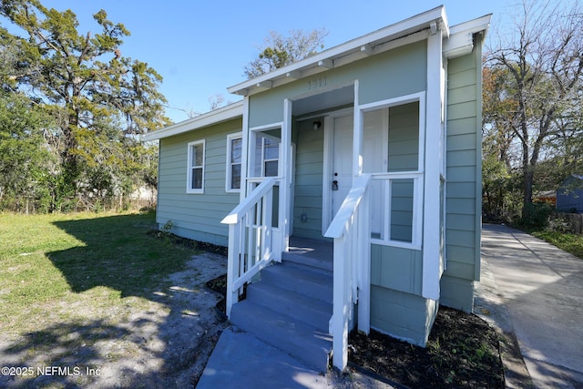 entrance to property with a yard