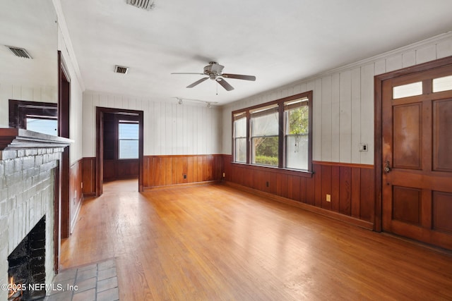 unfurnished living room with ceiling fan and light wood-type flooring