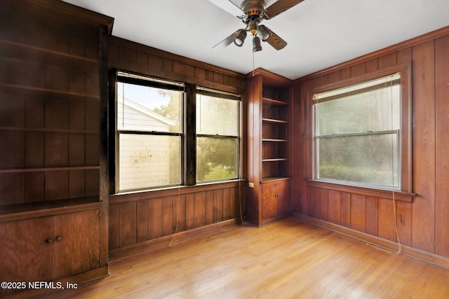 spare room with ceiling fan, a healthy amount of sunlight, and light hardwood / wood-style floors