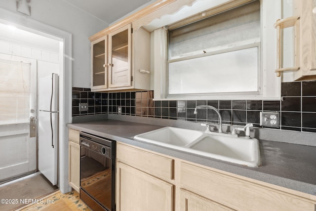 kitchen featuring light brown cabinetry, tasteful backsplash, sink, black dishwasher, and plenty of natural light