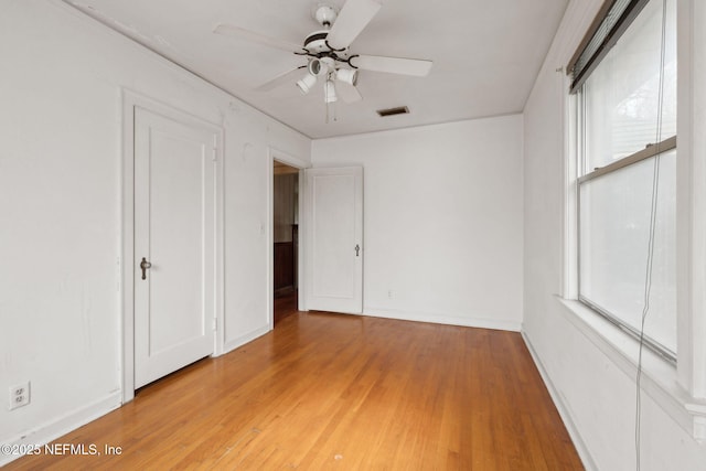 unfurnished bedroom featuring wood-type flooring and ceiling fan