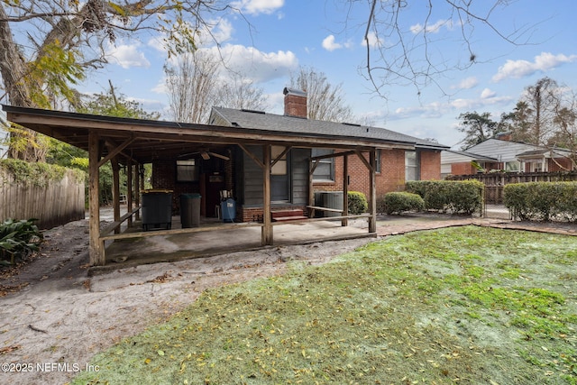 back of house featuring a lawn, ceiling fan, a patio, and central AC unit