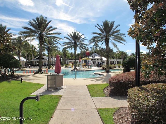 view of pool featuring a patio area and a yard