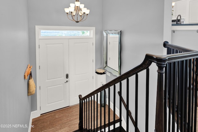 foyer entrance featuring an inviting chandelier