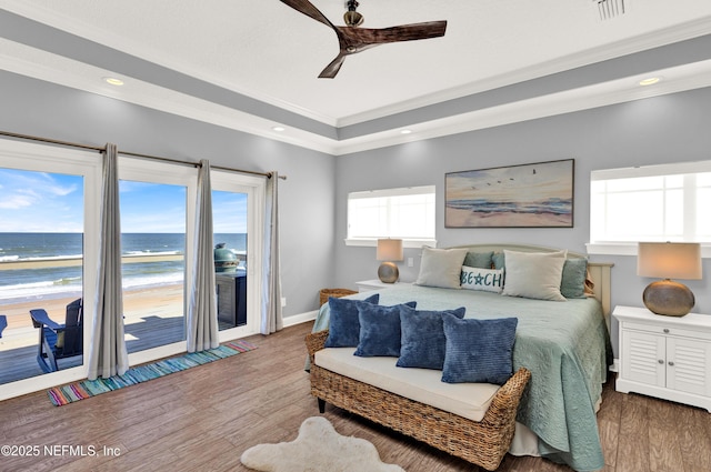 bedroom with access to outside, a water view, ceiling fan, hardwood / wood-style flooring, and ornamental molding