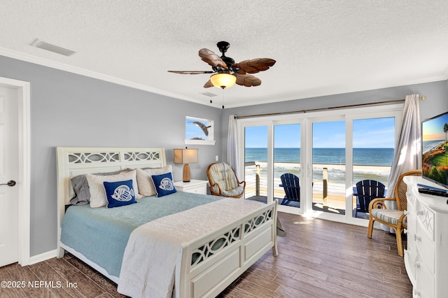 bedroom featuring dark hardwood / wood-style flooring, ornamental molding, ceiling fan, and access to exterior