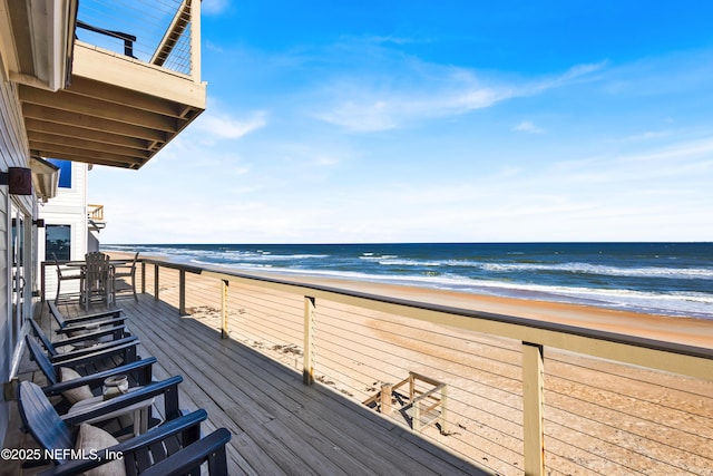 exterior space with a water view and a view of the beach