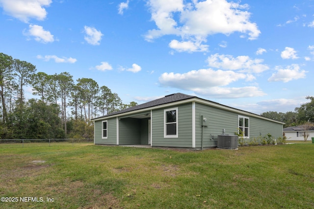 back of house featuring a lawn and central AC