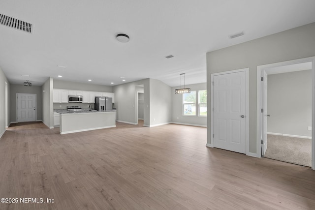 unfurnished living room with light wood-type flooring