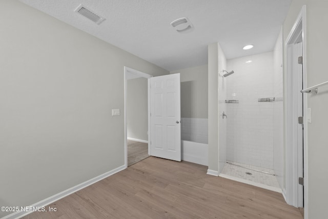 interior space featuring light hardwood / wood-style floors and a textured ceiling