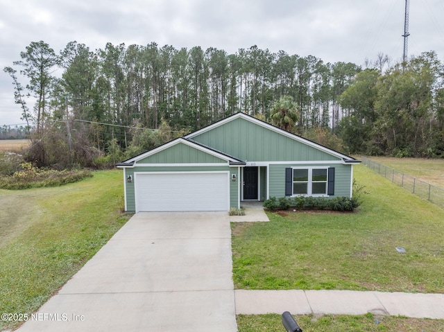 view of front of house with a front yard and a garage